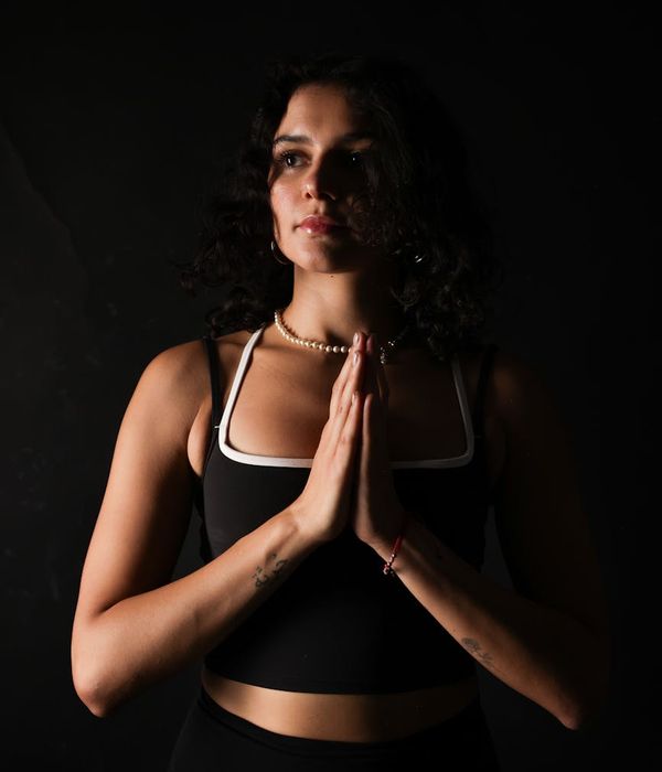 Woman in a calm yoga pose, embodying balance and focus.
